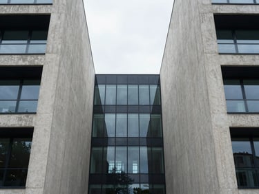 Symmetrical architectural details of modern concrete and glass structures, clean straight lines, overcast daylight