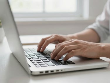Close-up of hands typing on a modern laptop keyboard, clean home desk environment, soft morning daylight, 35mm lens.