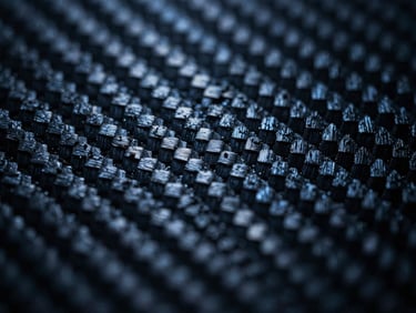 Macro photograph of raw carbon nanomaterial matrix, high-contrast backlighting emphasizing structural integrity, cool-toned laboratory light, deep slate tones