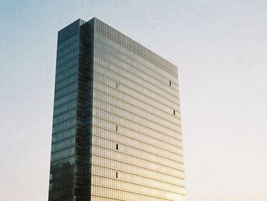 Wide architectural angle of high-end minimalist coastal skyscraper facade in Balneário Camboriú, soft golden hour sunlight reflecting off structured glass panels, medium format film