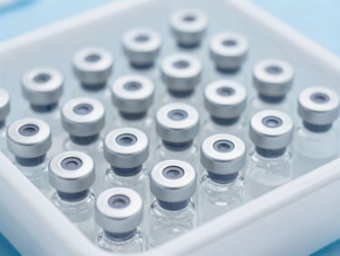 Close-up of sterile medical vials arranged in a clean, temperature-controlled cold-chain tray, sharp focus, clinical lighting.