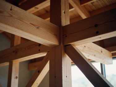Close-up of exposed heavy timber framing with precise mortise and tenon joints, dramatic side-lighting emphasizing the raw wood texture, 35mm film look