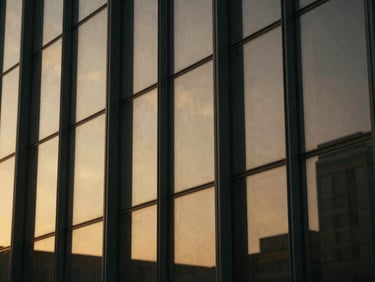 Extreme close-up of abstract geometric glass panels reflecting golden-hour light, architectural detail, cinematic.