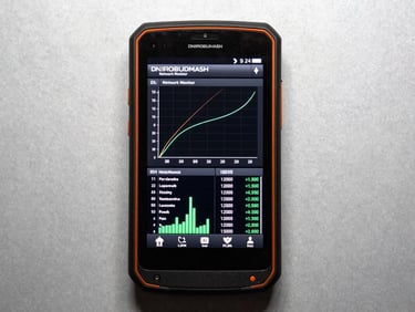 High-contrast screenshot of DNIROBUDMASH Network Monitor app interface on a rugged Android device, displaying network graphs and data usage, monospaced font, harsh industrial lighting, safety orange accents, macro lens, flat lay.