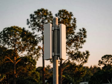 A modern utility pole with outdoor Wi-Fi access points mounted, towering pines and a soft dusk sky in the background, warm natural tones, 35mm.