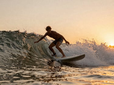 Dynamic shot of a person carving a wave at sunset, golden hour light, warm earthy tones with vibrant orange accents, motion blur, 35mm film look.