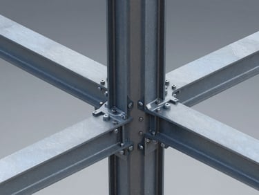 A high-resolution 3D Tekla Structures model screenshot showing complex heavy steel column-to-beam connections with gusset plates and bolts, crisp technical rendering, cool studio lighting.
