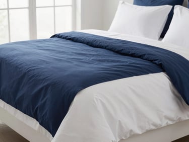 Perfectly made bed with crisp white long-staple cotton bed sheets and navy blue duvet cover, sunlit hotel-style bedroom, soft natural window light, crisp whites and deep navy tones, shallow depth of field, 35mm