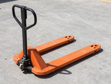 Crisp industrial photography of a safety orange hand pallet truck on a concrete floor, bright warehouse daylight, sharp focus, 35mm
