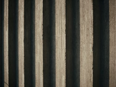 Extreme close-up of architectural concrete textures, brutalist design, dramatic shadows, high-contrast natural light