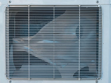 Close-up of perfectly clean aluminum cooling fins on an air conditioner coil, shining metal, pristine and sanitized.
