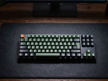 minimalist flat-lay of a developer workspace with a mechanical keyboard and dark slate desk mat, cool dim studio lighting, sharp focus