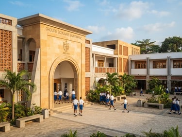 Wide environmental shot of the clean, structured school entrance of Saint Marc in Abidjan, bright natural West African daylight, architectural lines, warm golden tones.