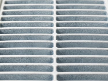 Close-up of a clean technical air conditioning filter, sharp focus, cool slate tones, 35mm lens
