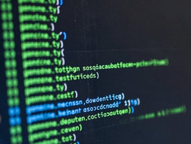 Macro close-up of a dark computer screen displaying green and blue lines of terminal code with sharp contrast, technical interface