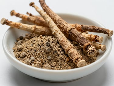 Extreme close-up of raw ashwagandha root and powder in a small clean ceramic dish, cool diffused studio lighting, overhead framing on white surface, ingredient-texture detail