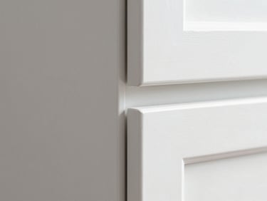 Macro shot of a flawless white painted cabinet corner showing crisp, clean edges and zero drips, bright daylight, sharp architectural detail