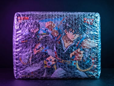 Close-up of a premium anime action box wrapped in thick layers of bubble wrap, dramatic neon purple and cyan studio lighting, dark textured background, sharp focus, 85mm lens