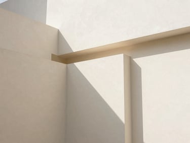 Abstract geometric composition of white plaster blocks casting sharp, clean shadows under soft natural daylight, minimalist architectural study, warm sand undertones
