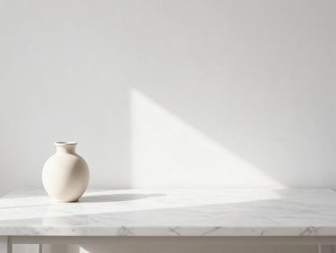 Clean, uncluttered workspace with a marble desk, a single ceramic vase, soft natural light streaming from the side, minimalist aesthetic.