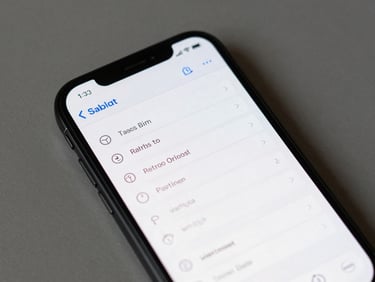 Android phone screen close-up showing a minimal task-list app interface, natural overhead ambient light, phone resting flat on a plain grey surface