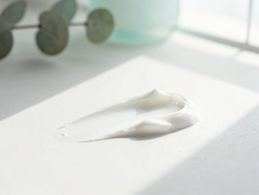 Macro shot of white skincare cream texture with soft shadows, sunlit, minimalist botanical detail in the background, 35mm