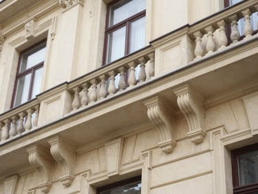 Architectural detail of a historic building on Cuza Vodă street, suggesting official institutions, soft natural daylight, deep navy and warm paper tones, macro lens, shallow depth of field