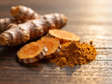 Macro close-up of fresh turmeric root slices and powder on a dark wooden surface, golden lighting, soft reflections, 35mm.