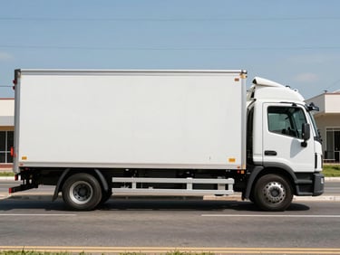A clean, white modern box truck parked on a wide street in Fortaleza, bright daylight, clear side profile of the vehicle