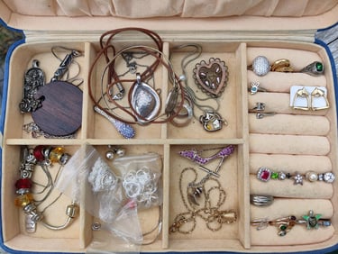 Tray of thrift store vintage gold and silver jewelry.