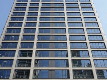 High-rise commercial building facade with advanced structural glazing, crisp architectural lighting