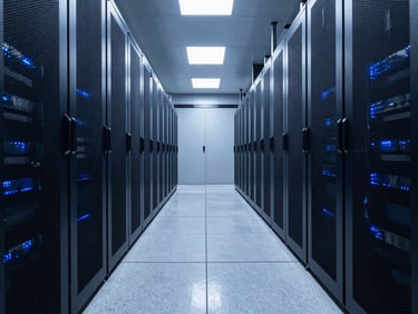 A high-end regional data center corridor, clean polished concrete floors reflecting cool blue server rack lights, symmetric perspective.