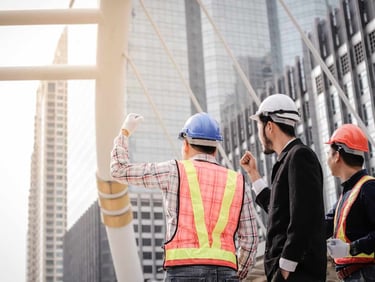 a group of construction workers standing in front of a building