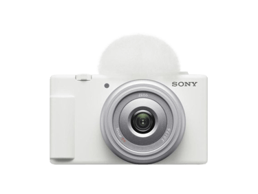White Sony ZV-1F vlog camera with a Zeiss lens and white wind screen on a black background.