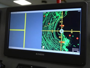 Industrial telemetry screen inside a marine vessel control room, showing subsea sonar mapping and pipeline coordinates, soft blue monitor glow.