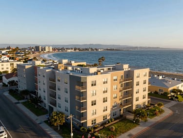 Aerial coastal view of a mid-sized multi-family apartment building in the South Bay, bright daylight