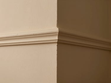 Close-up of a perfectly painted interior wall corner, smooth texture, warm sand color, professional clean lines, architectural detail