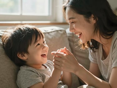 Soft directional window light illuminating a mother and child sharing a quiet laugh on a linen sofa, natural sun flares, close-up on intertwined fingers