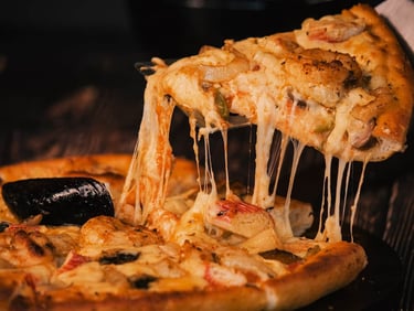 a pizza with cheese and a slice of pizza