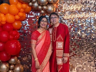 Couple in front of the rose gold shimmer wall, garland and neon sign for their annivesary in Brisbane.