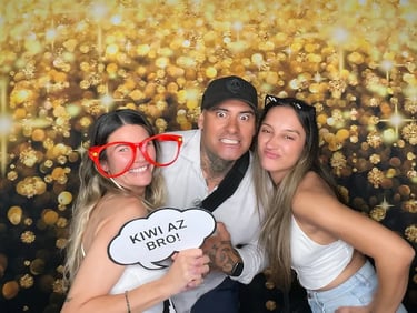 Guests in the golden sparkle photo booth for Kaea's 21st celebration in Gold Coast.