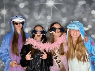 Brianna's guests in the photo booth at her party in Redland Bay with oversized glasses.