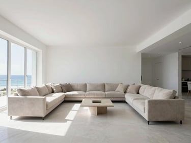 A luxurious coastal living room, half painted a crisp white, half still in its old, muted beige, showcasing a dramatic before-and-after transformation. Bright natural daylight, wide architectural shot.