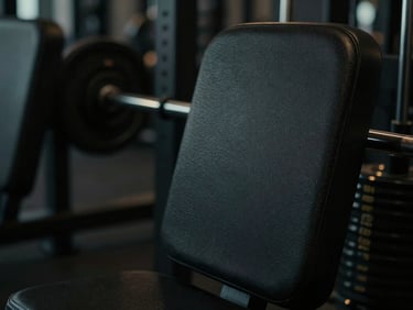 Moody cinematic photography of premium dark textured gym equipment, dramatic low-key lighting, shallow depth of field, 35mm.