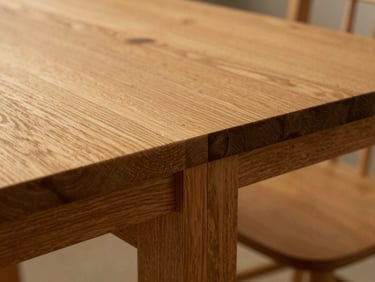 Close-up detail shot of a hand-cut mortise and tenon joint on a solid oak table, shallow depth of field, warm natural wood tones, 35mm