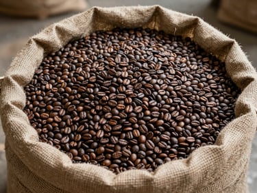 Overhead shot of dried robusta coffee beans spread on a burlap sack under diffused natural light, warehouse floor visible at edges