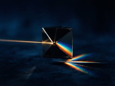 Macro photography of an elegant, dark glass prism refracting a single beam of warm golden light against a deep midnight blue background, minimalist geometry, razor-sharp focus