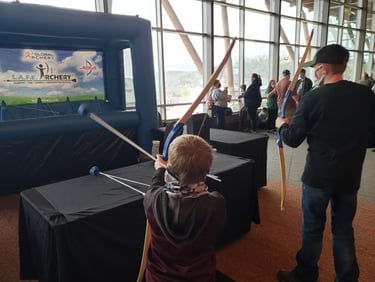 Two young archers shooting archery on the hover ball system by safe archery. 