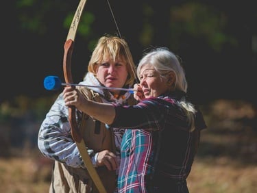 Joella giving archery lesson. 