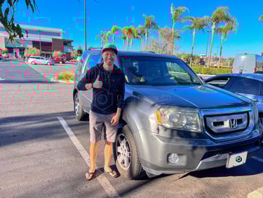 man standing in front of 2009 honda pilot